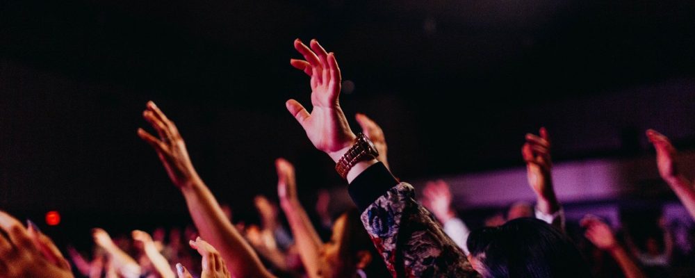 people raising their hands up